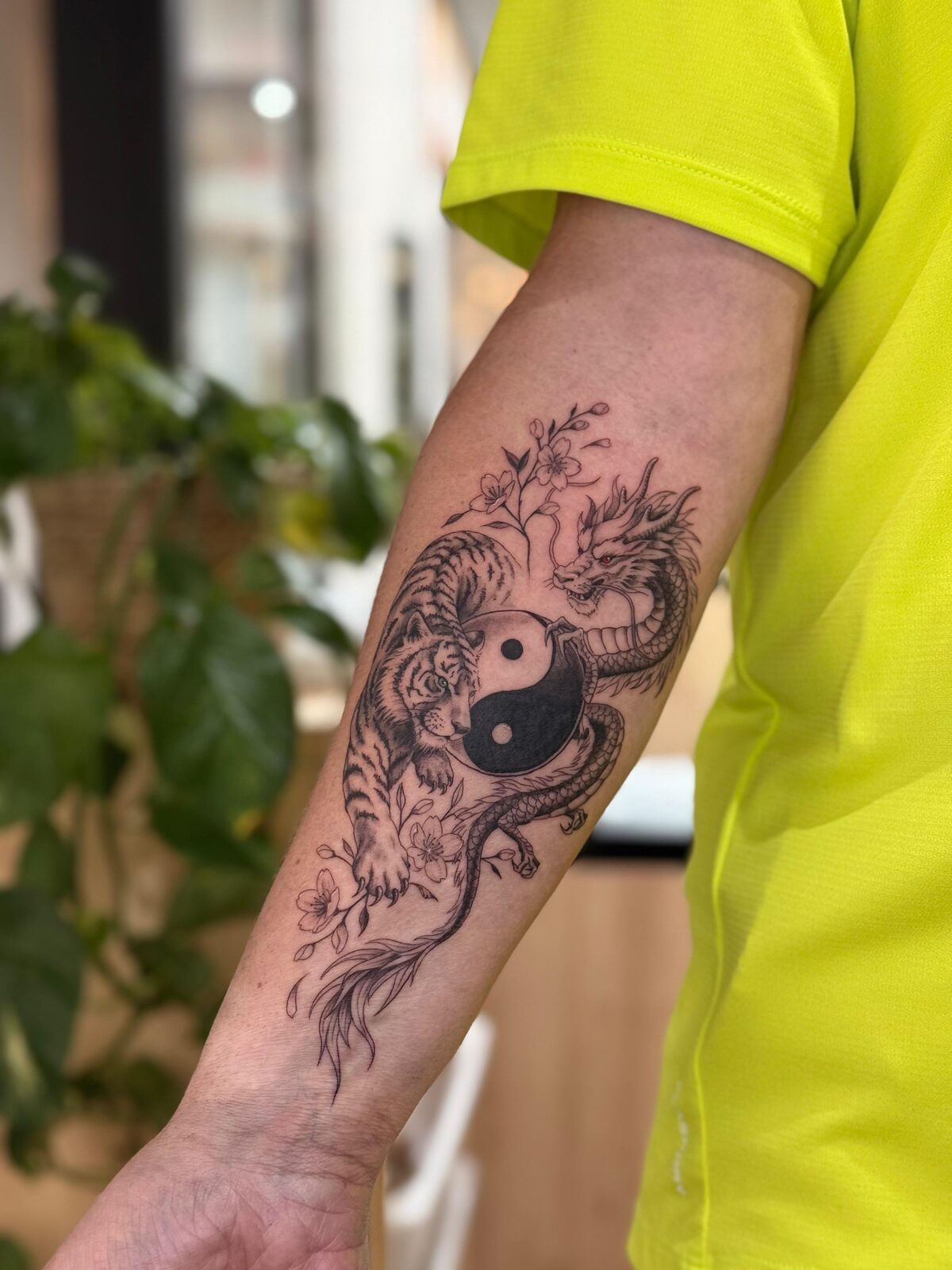 Tigre y dragón con yin yang en el antebrazo